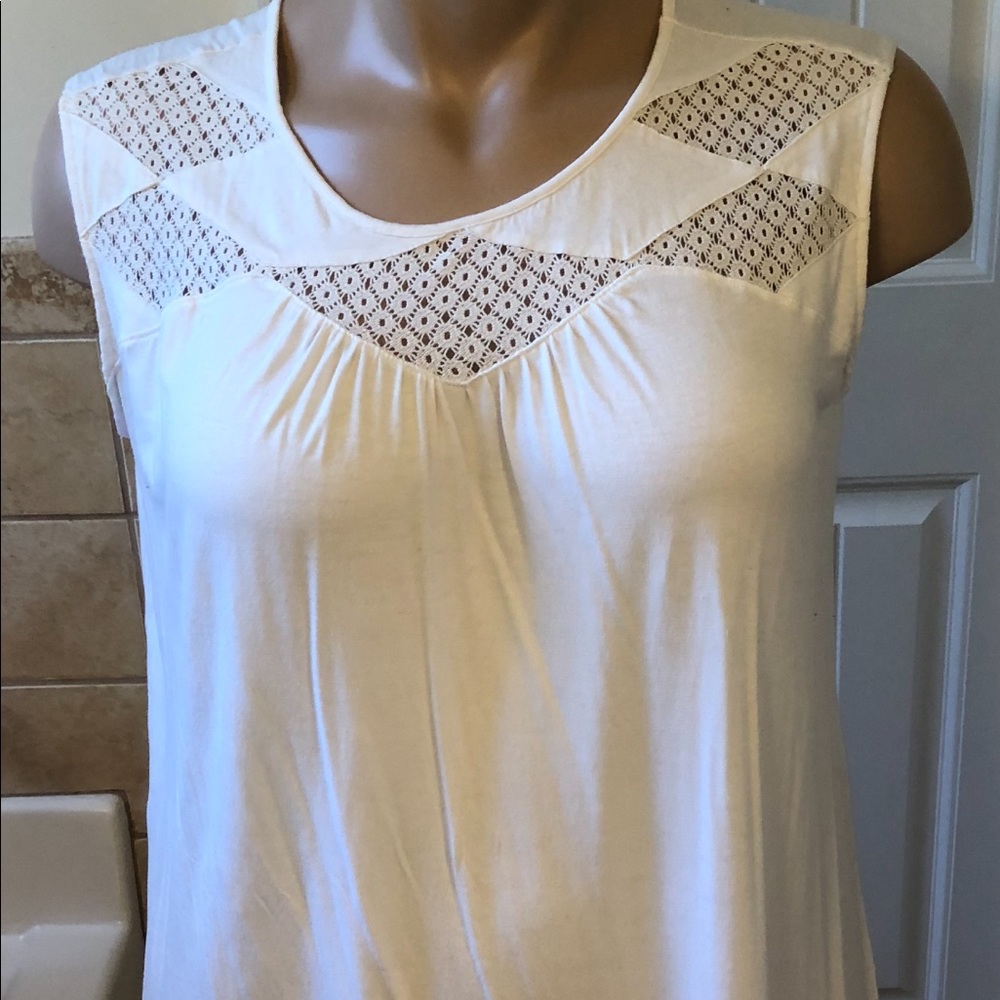 White sleeveless blouse with design at neckline